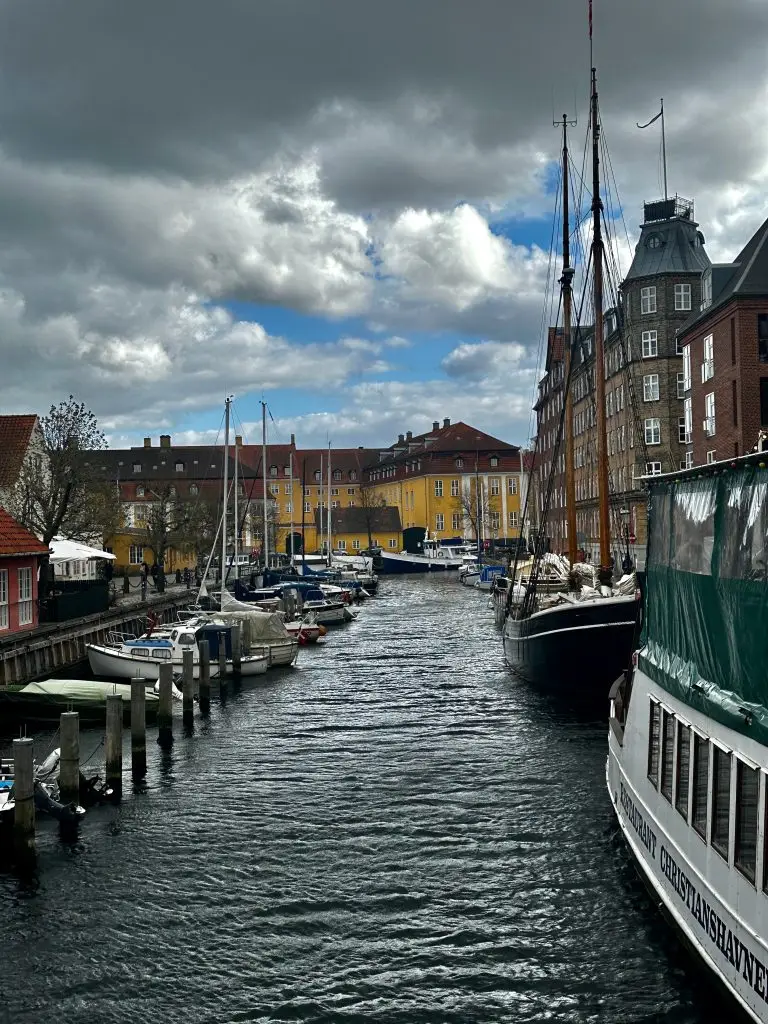 Tall Ships, Copenhagen Tall sailing ships and boats moored along a Copenhagen canal under heavy clouds