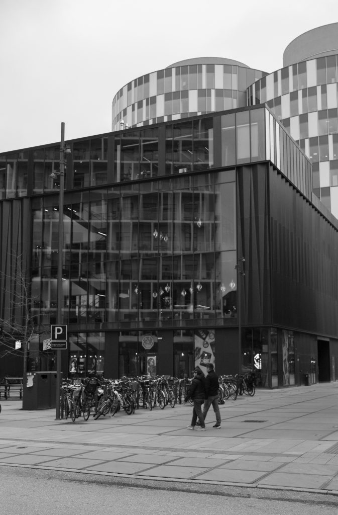 Curved Architecture, Copenhagen Modern Copenhagen architecture with curved upper floors, pedestrians and bicycles, black and white