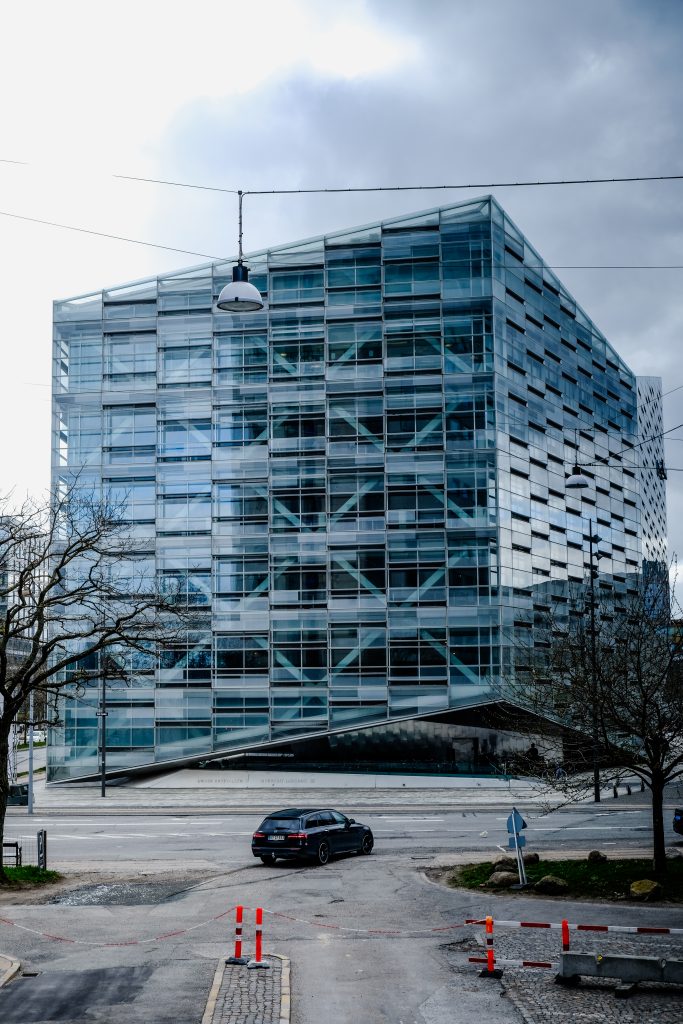 Glass Grid Modern glass and steel office building under a cloudy sky, Copenhagen