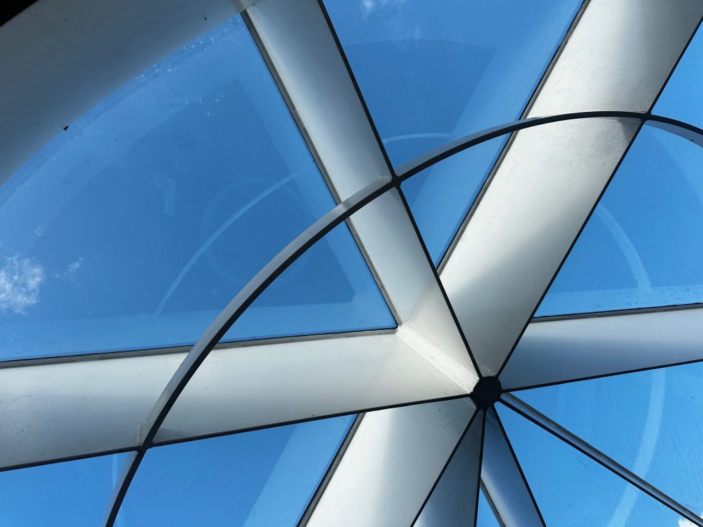 Glass Geometry, Copenhagen Abstract view of a curved glass and steel roof against a blue sky, Copenhagen