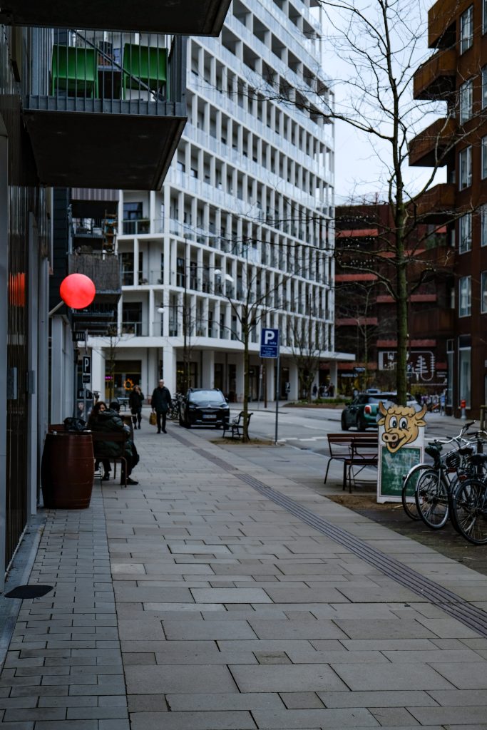 Red Lamp Modern residential street with a red hanging lamp and parked bicycles, Copenhagen