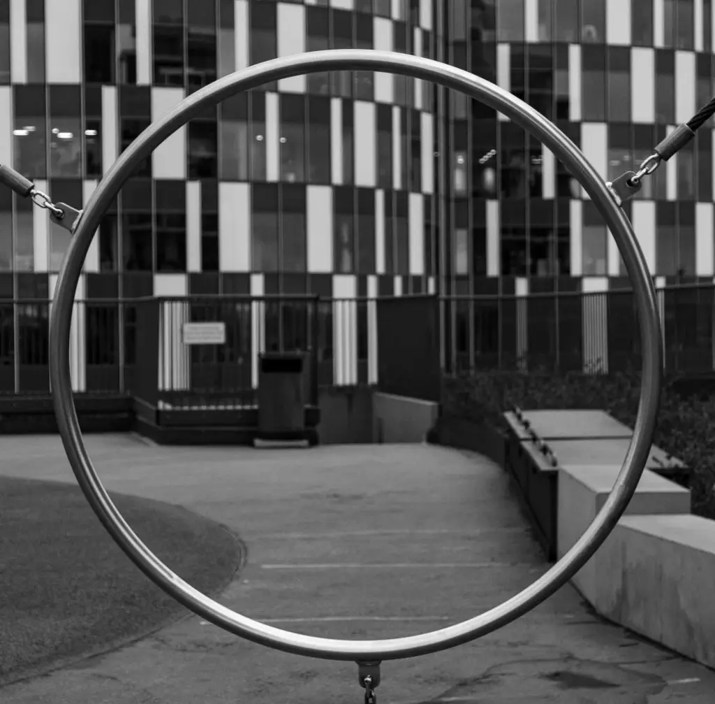 Steel Ring, Copenhagen Circular steel sculpture framing a modern facade in Copenhagen, black and white