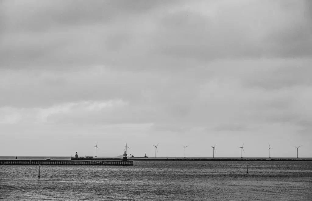 Sea Horizon with Wind Turbines Flat sea horizon with wind turbines and a distant pier near Copenhagen, black and white
