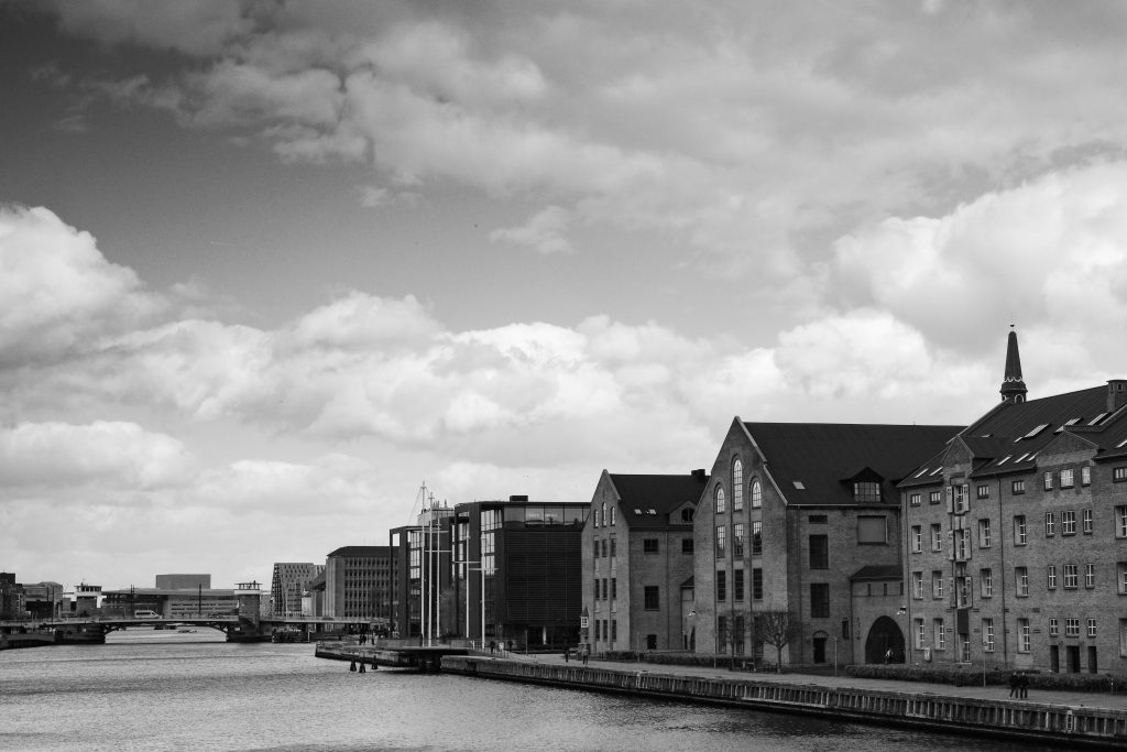 Waterfront Warehouses Historic brick warehouses along the Copenhagen waterfront under a cloudy sky, black and white