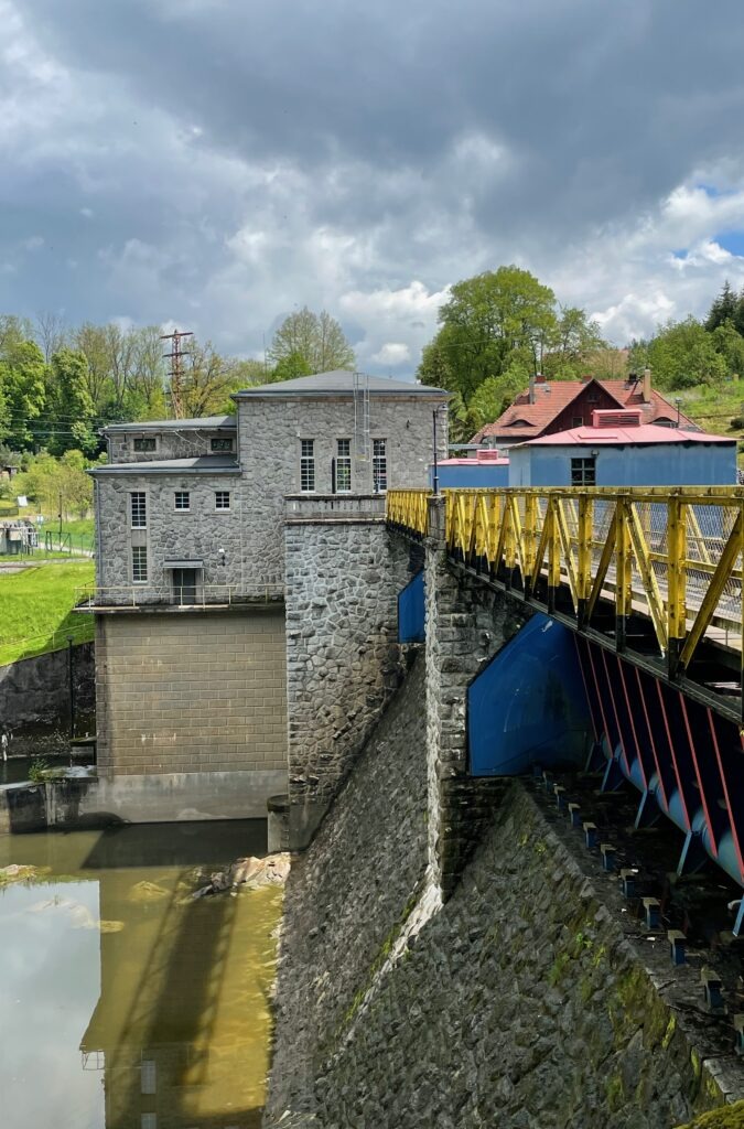 Wrzeszczyn Power Station Historic stone hydroelectric power station and yellow bridge at Wrzeszczyn on the Bóbr River, Lower Silesia