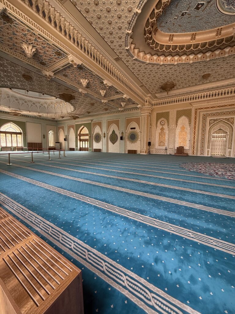 Spacious prayer hall interior with blue carpet inside a Tashkent mosque