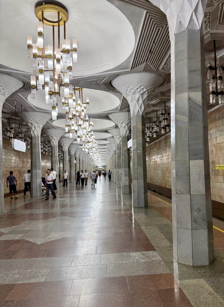 Ornate chandeliers lighting a corridor in a Tashkent metro station