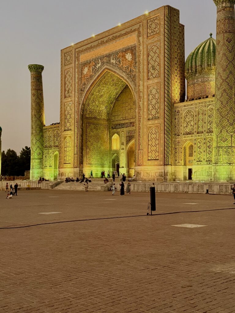 Dramatic night lighting on a madrasa facade in Samarkand, Uzbekistan