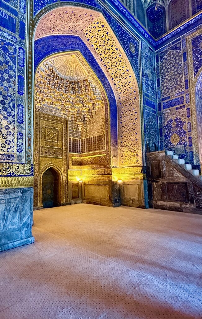 Illuminated tiled facade of Registan Square at night, Samarkand, Uzbekistan