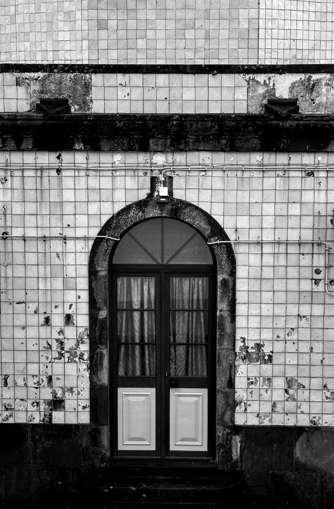 Black and white photograph of a historic tiled doorway in the Azores