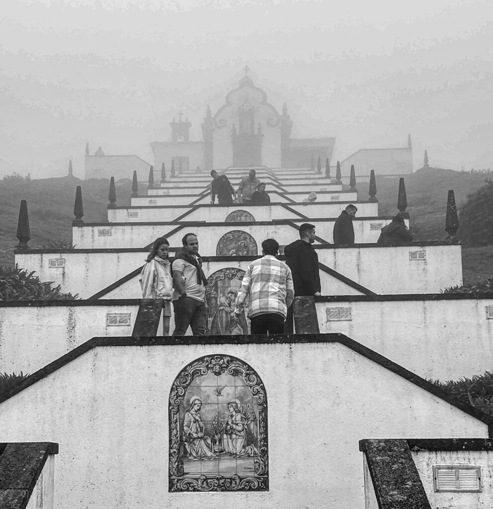 Black and white photograph of pilgrims walking up the stairway to Nossa Senhora da Paz church, Azores