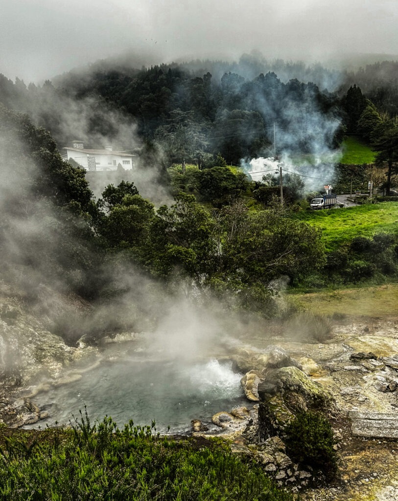 Steaming fumaroles and hot springs in a green volcanic valley, Furnas, Azores