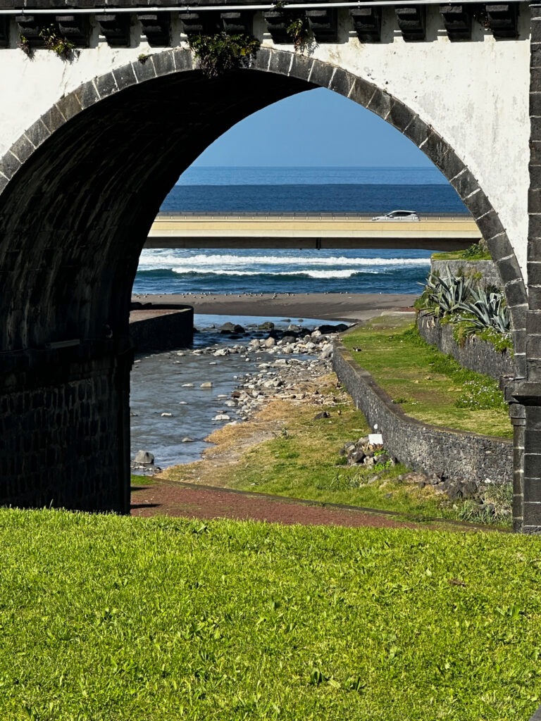 Atlantic Ocean and beach framed by a white stone arch, Azores