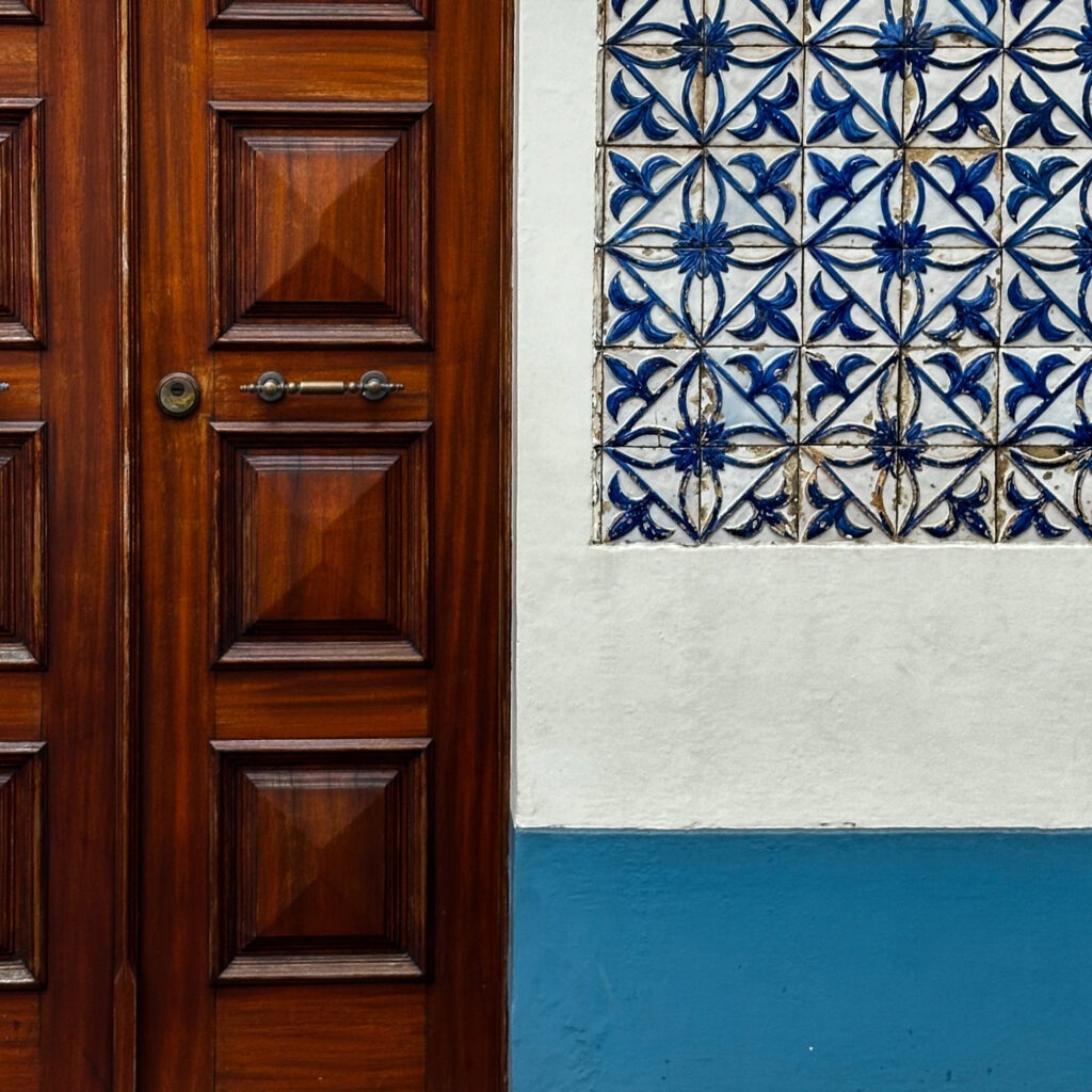 Traditional wooden door and blue azulejo tiles in an Azores village