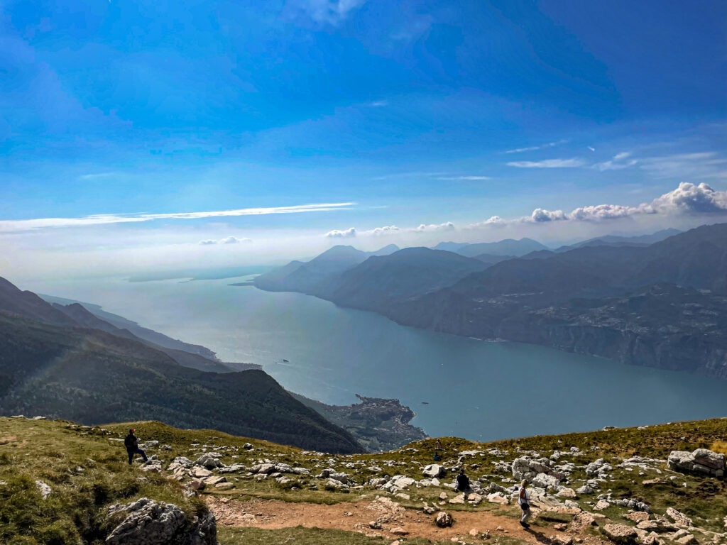 Wide view of lake and distant mountains merging with sky in soft blue tones, fine art landscape