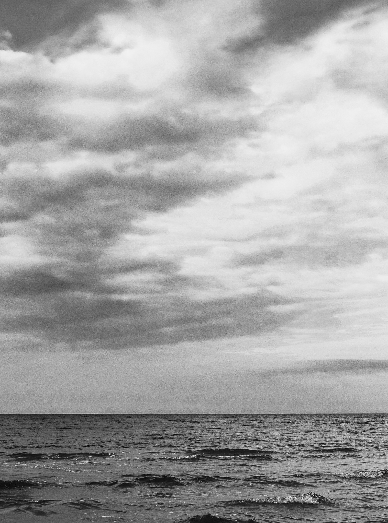Sky and sea divided by a single horizon, minimalist black and white seascape by Andrus Markus